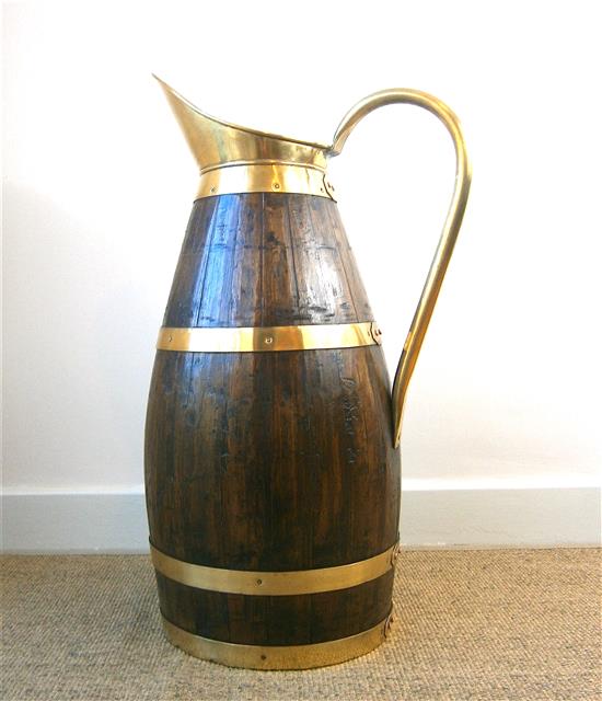 An oak and brass jug stick stand height 66cm